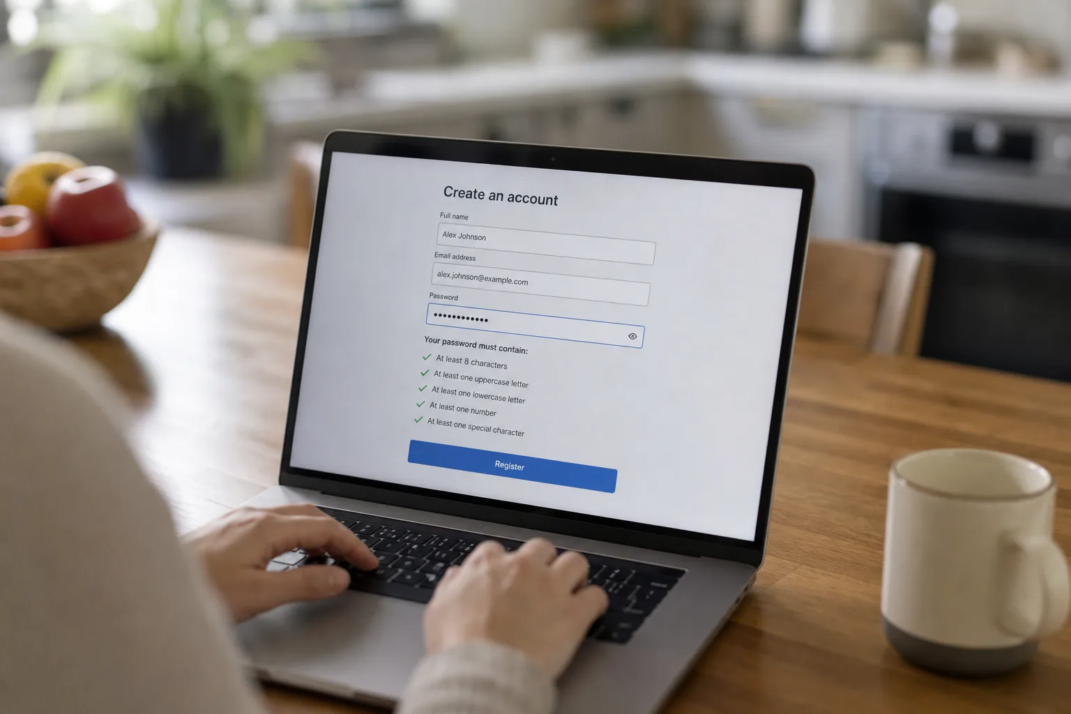 A laptop screen showing an account registration form with a password field and a list of composition requirements, seen over the shoulder of a person mid-typ...